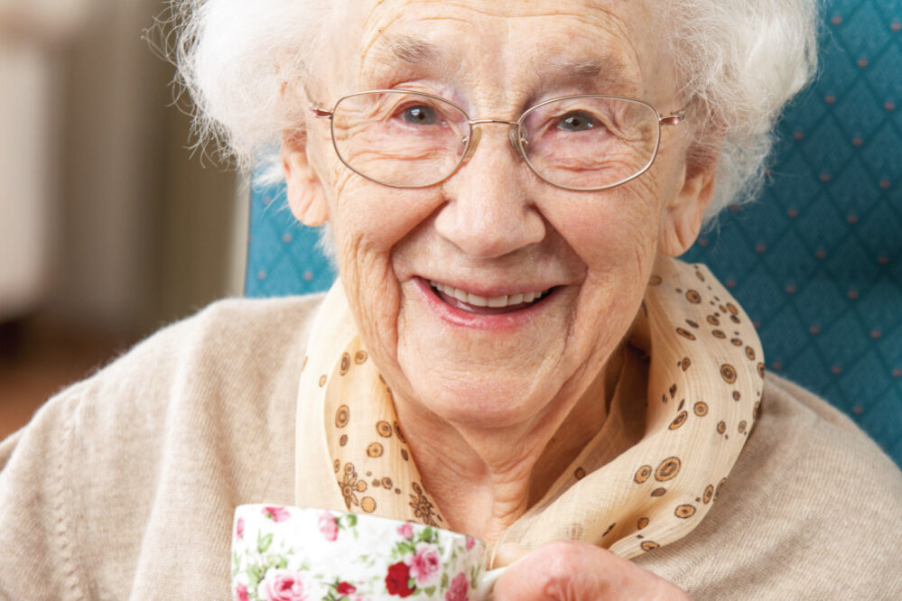 Happy-Senior-Woman-Enjoying-a-Cup-of-Tea Happy Senior Woman drinking a cup of tea