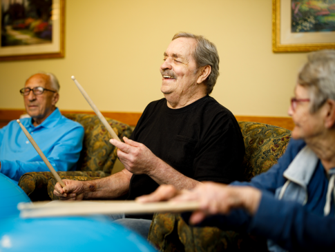 Senior resident enjoying drum circle