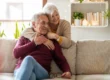 Senior resident sitting with family member in new apartment