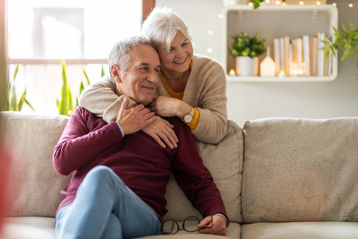 Senior resident sitting with family member in new apartment