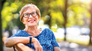 Senior woman relaxing on a bench at her assisted living community